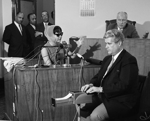 16 Dec 1964, Los Angeles, California, USA --- Witness Elisa Boyer, wearing a disguise, testifies during the Coroner's Inquest of the murder of soul singer Sam Cooke. --- Image by © Bettmann/CORBIS
